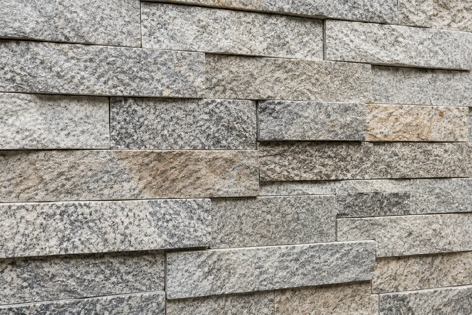 Natural granite stone wall cladding in grey and earthy tones
